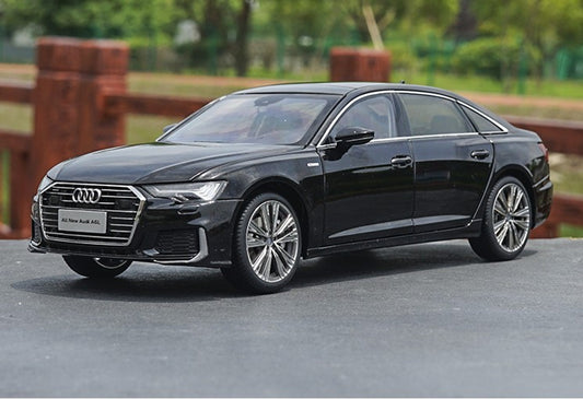 Black Audi car on a road with a blurred background